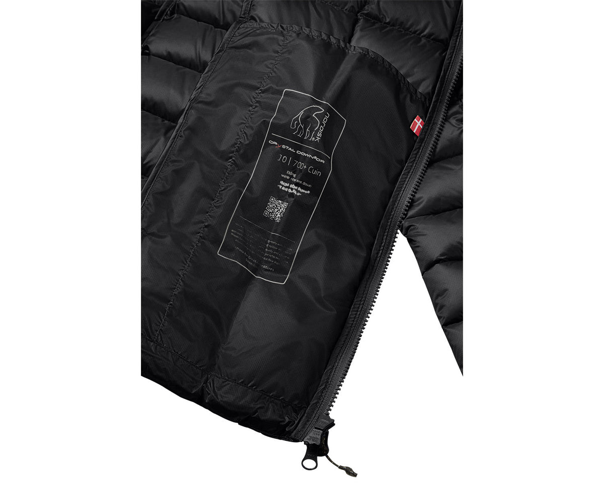 Close-up of a black jacket with a brand label on a white background
