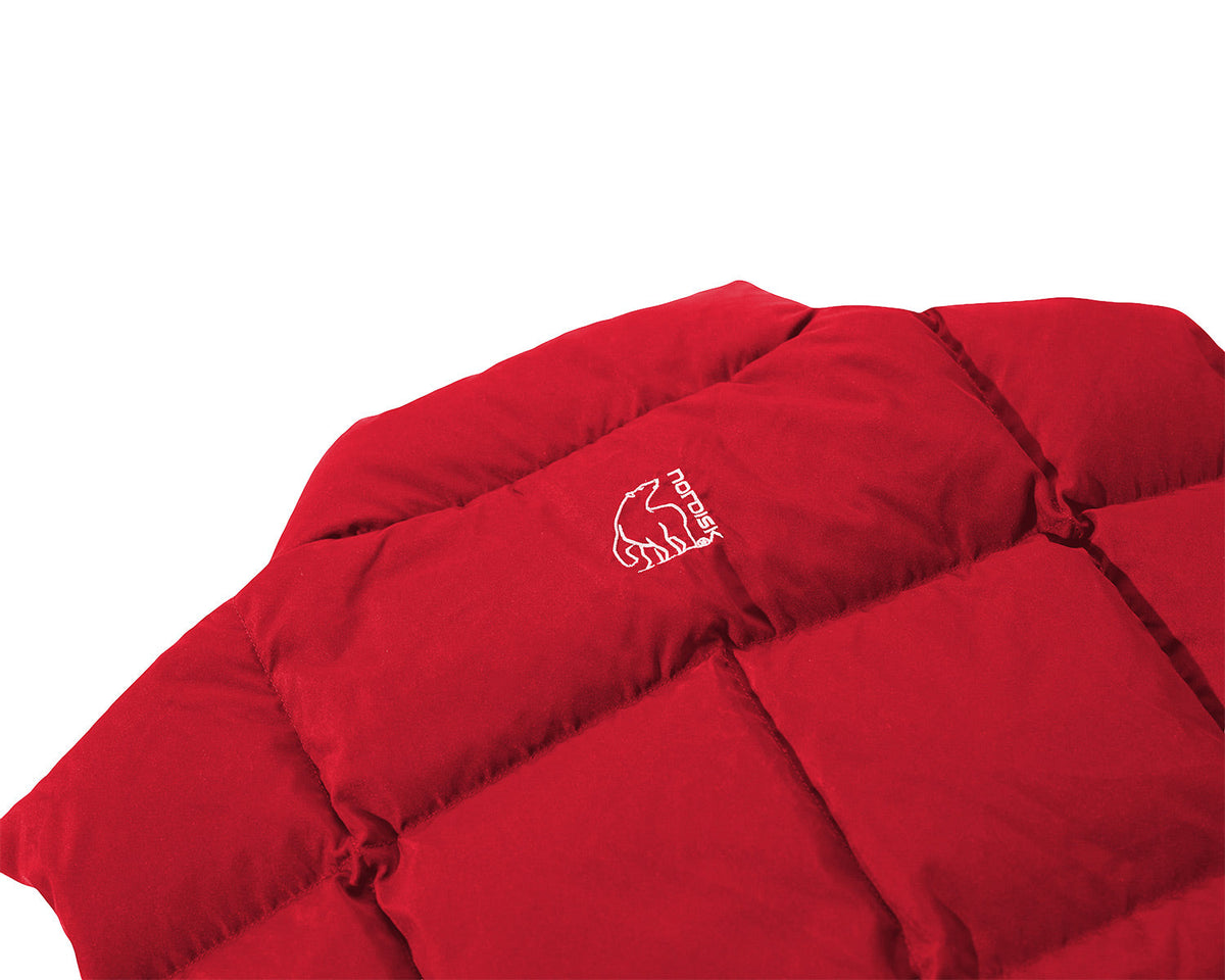 Red quilt with a logo on a white background