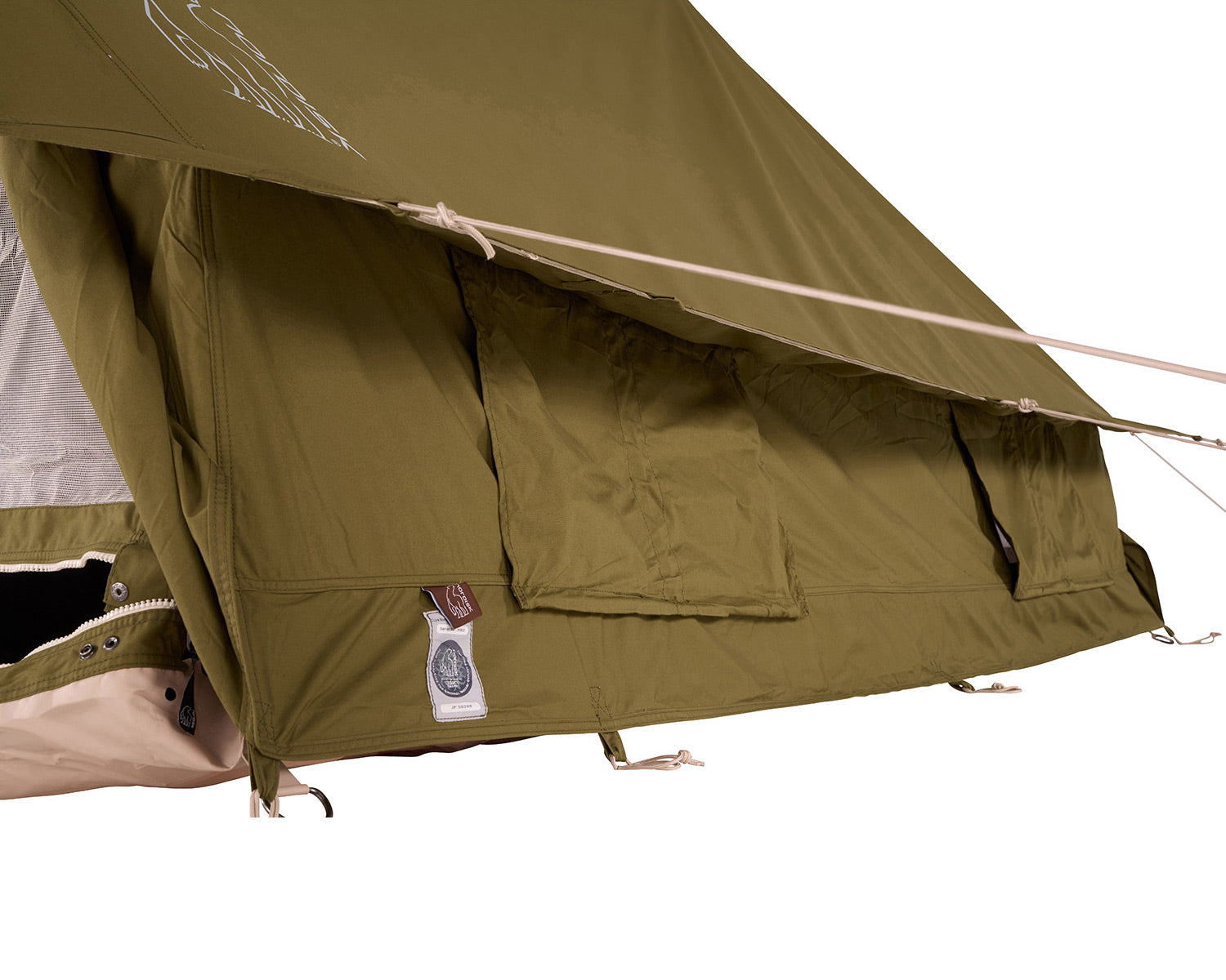 Close-up of a green tent with a visible brand label on a white background