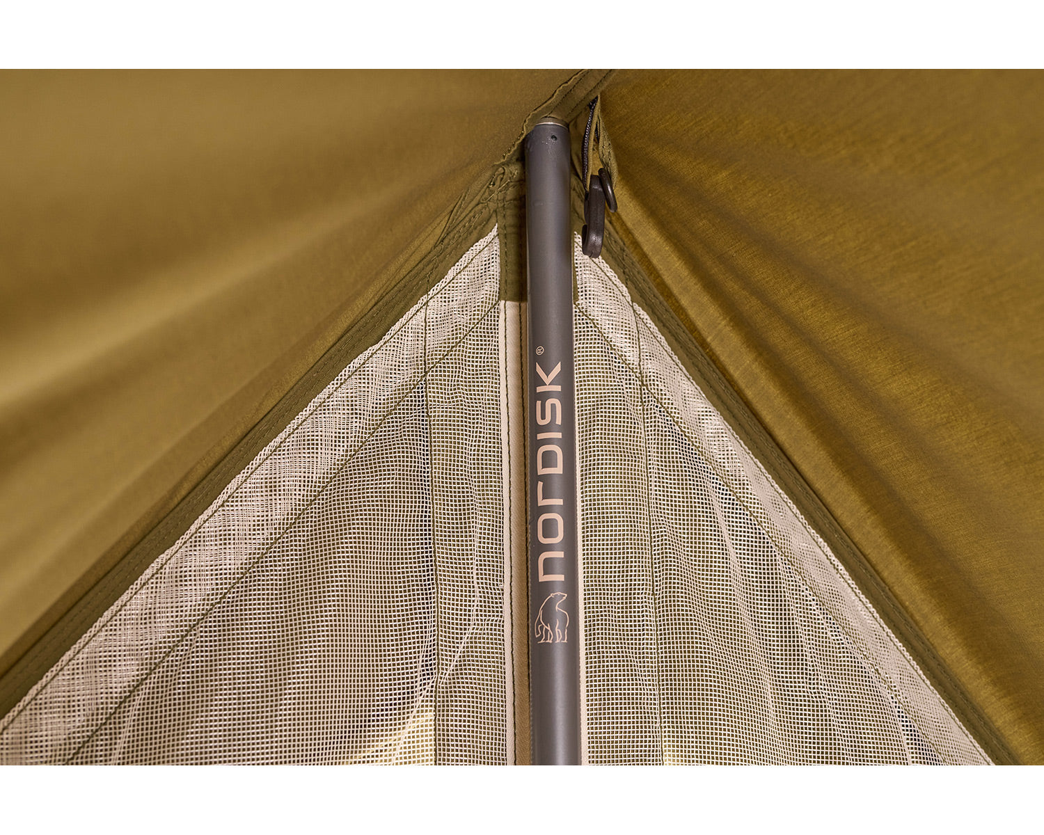 Close-up of a camping tent with Nordisk branding on a brown background