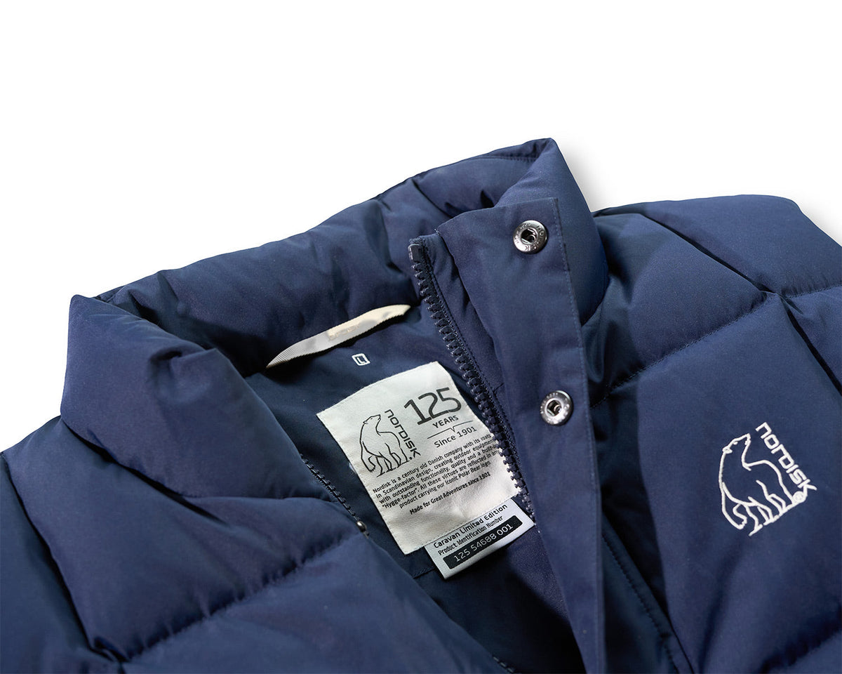 Navy blue jacket with brand logo and tag on a white background